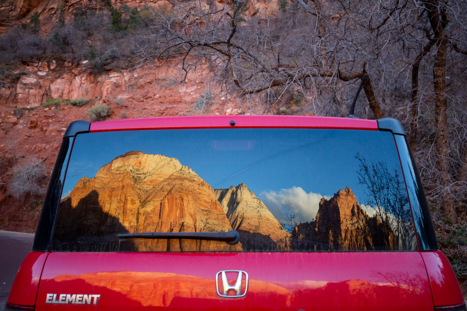 Zion National Park reflected in the window of a Honda Element